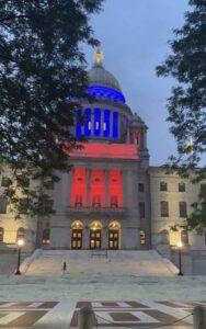 Read more about the article Update: Raimondo caves to public pressure and lights Rhode Island State House in red,white and blue!